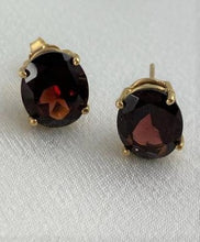 Load image into Gallery viewer, Garnet earrings oval shaped set on 14 KT yellow gold
