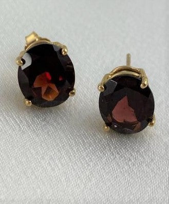 Garnet earrings oval shaped set on 14 KT yellow gold